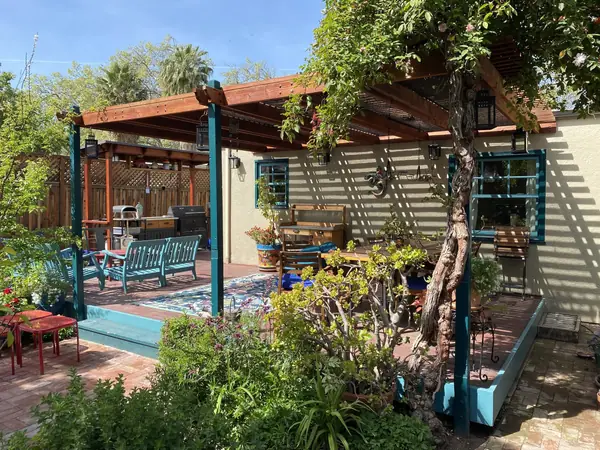 Wooden pergola over a garden patio with planters